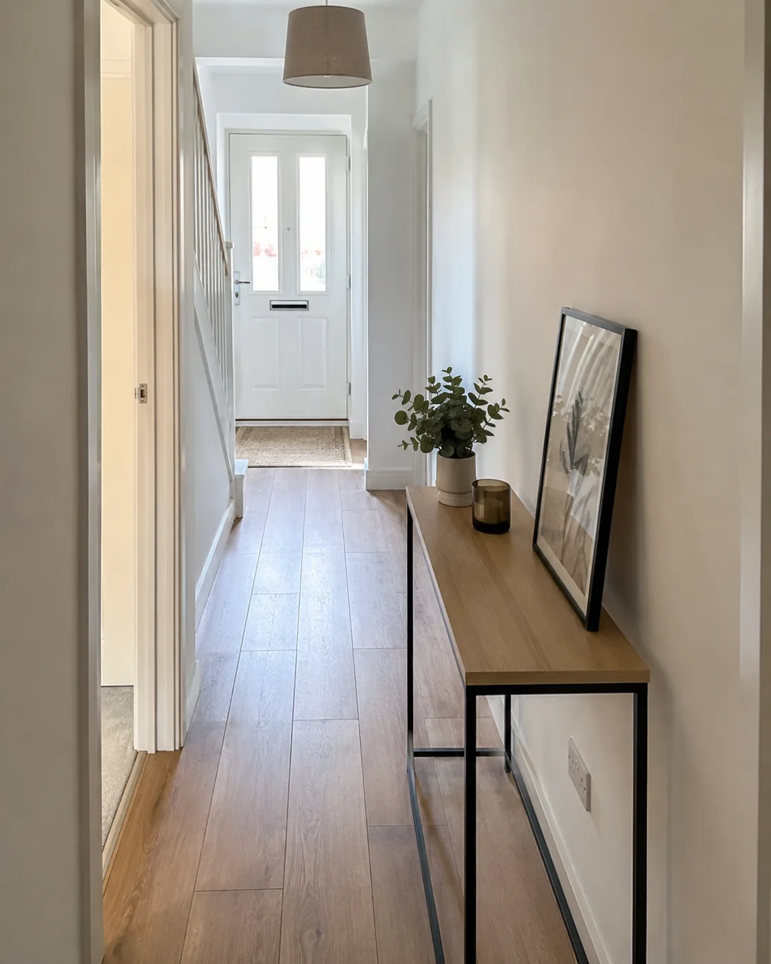 Narrow minimal console table in bright hallway
