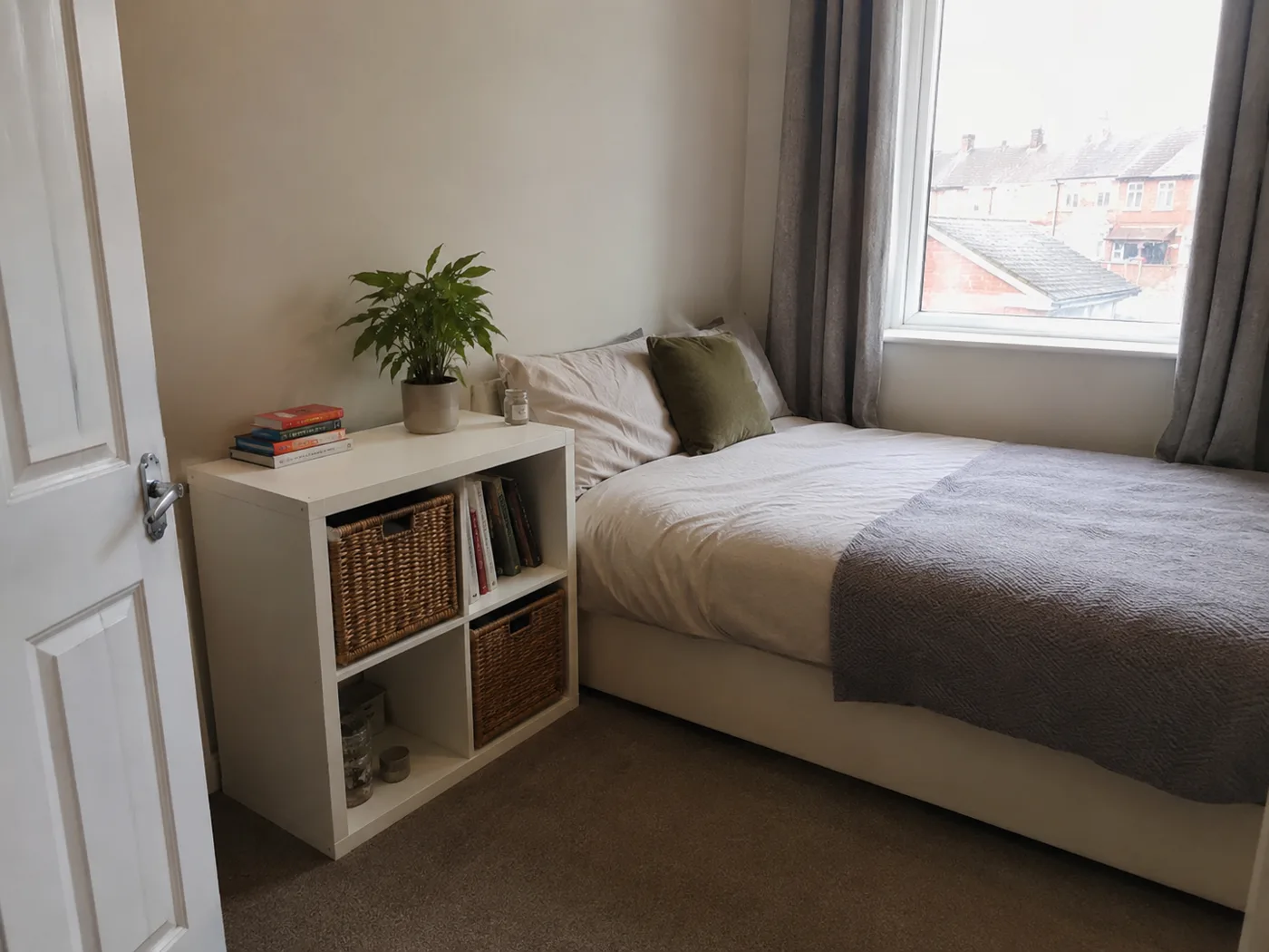 IKEA Kallax cube shelf used as bedside table with plant