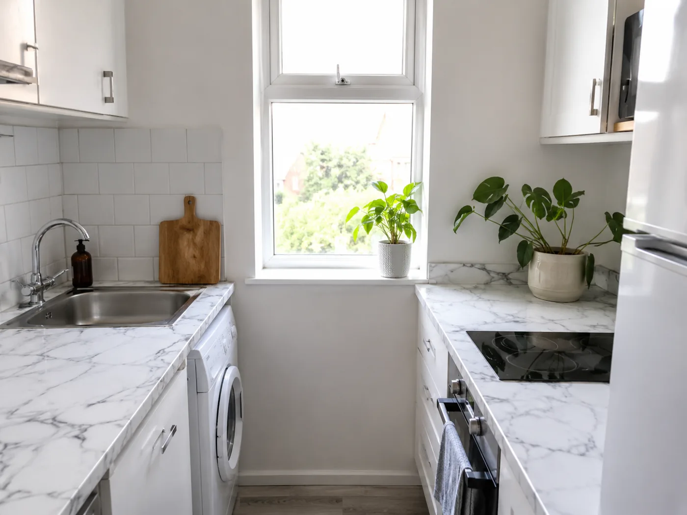 Kitchen with peel and stick marble effect contact paper on worktop