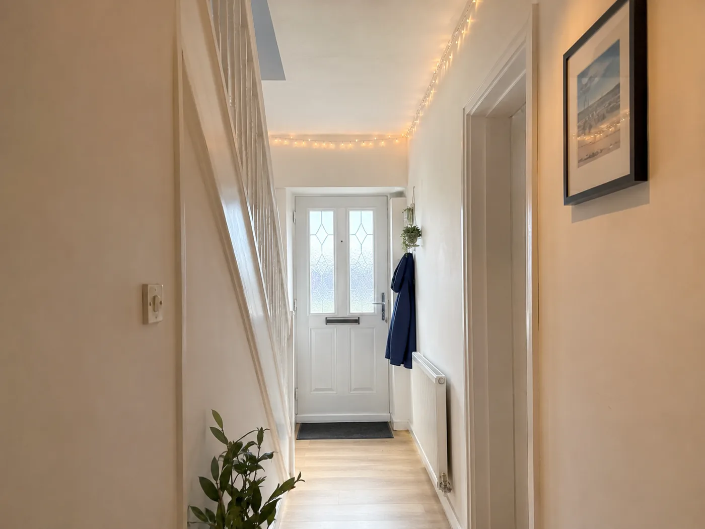 Minimal hallway with warm fairy lights along ceiling edge