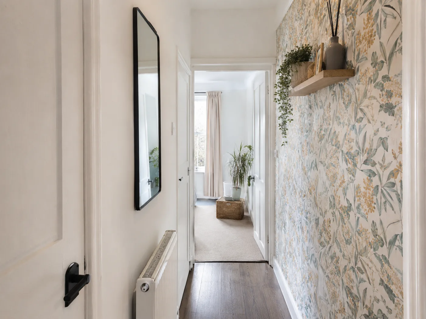 Peel-and-stick wallpaper on hallway wall with botanical pattern