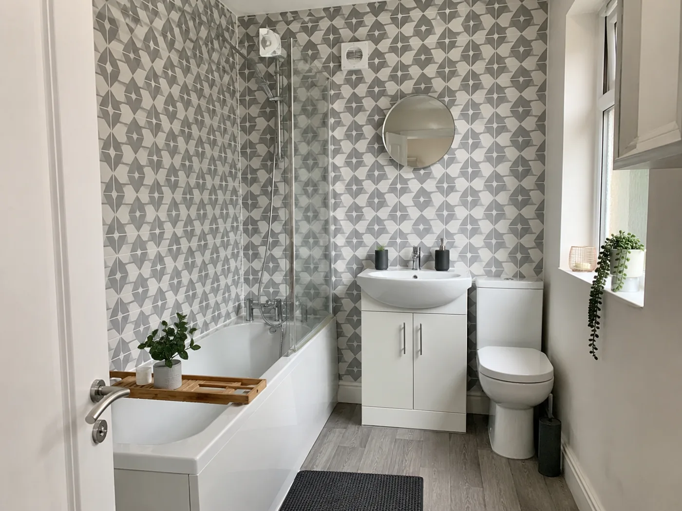 Removable peel-and-stick geometric tiles on bathroom wall