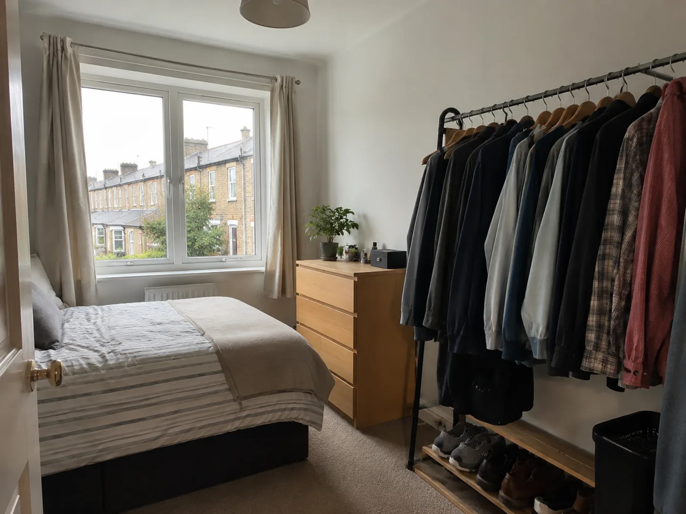 Freestanding clothes rail with shoes stored underneath