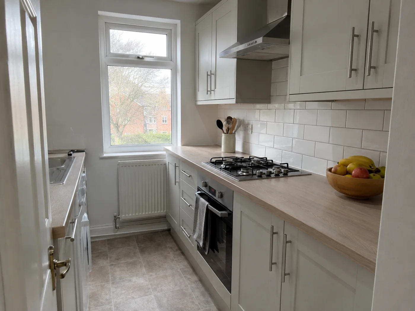 Clean minimal UK kitchen with clear counters and organised layout